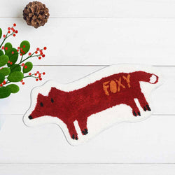 Fox non slip bathroom mat on a white wooden floor with pinecone.